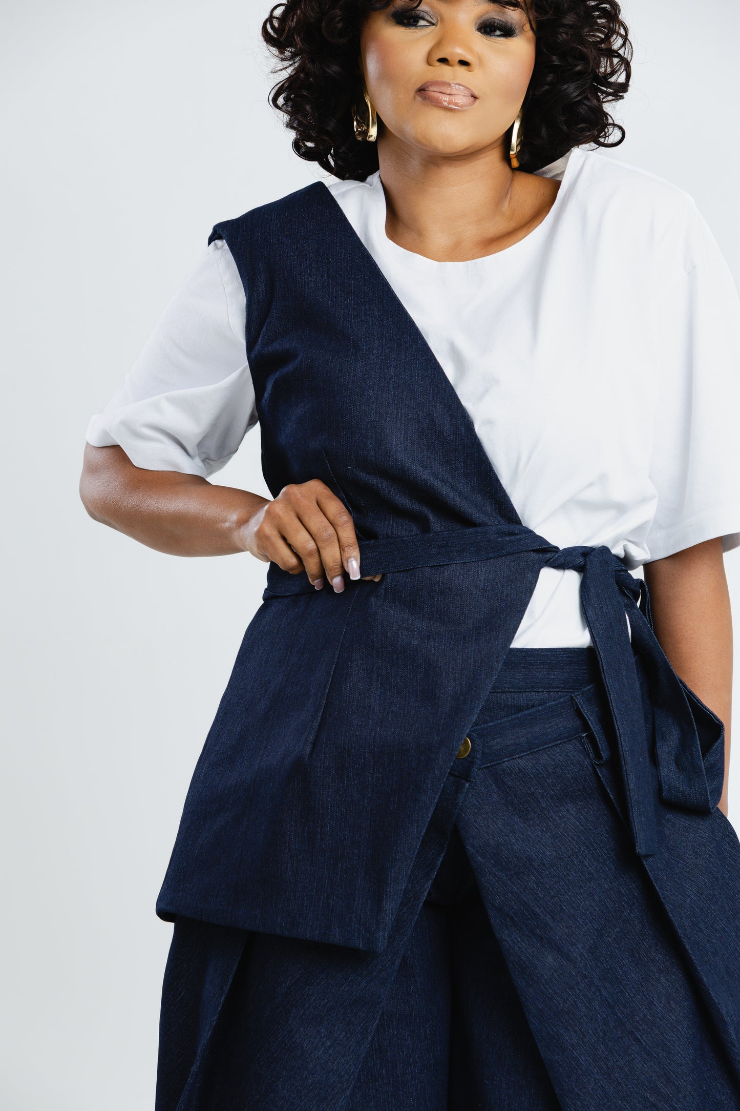 Off Cut Denim asymmetric top showing the one-shoulder panel and wrap front