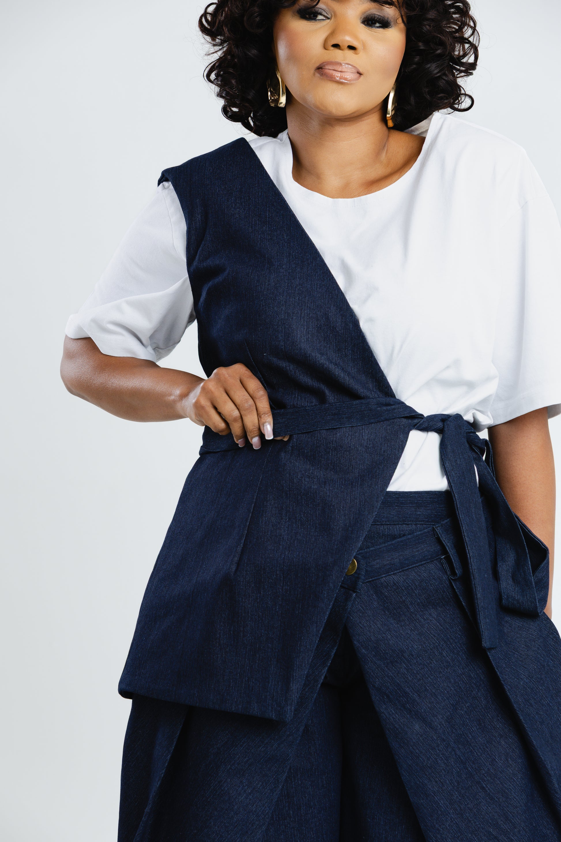 Off Cut Denim asymmetric top showing the one-shoulder panel and wrap front