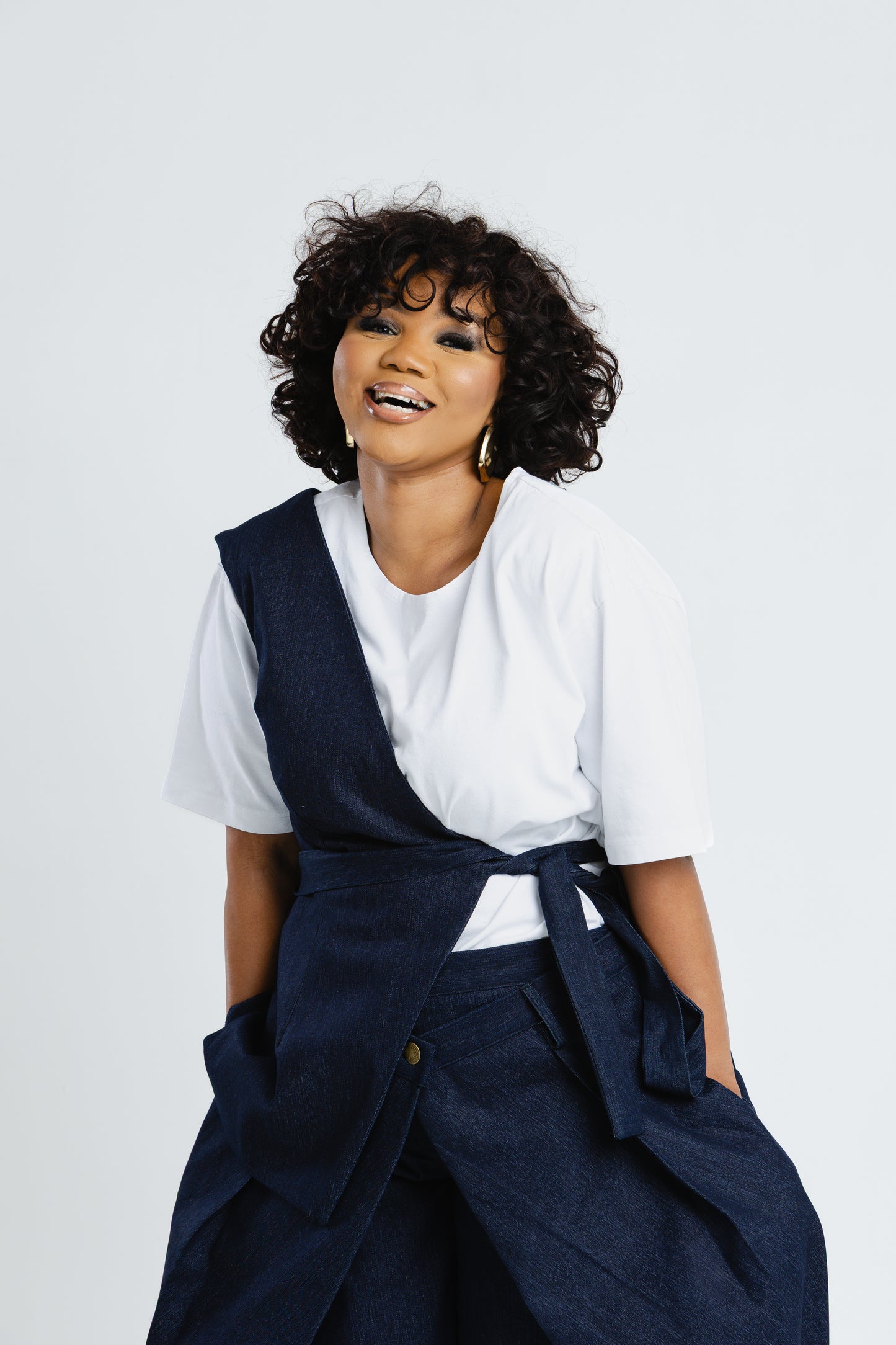 Off Cut Denim top in deep indigo with asymmetric shoulder panel and waist tie, front view